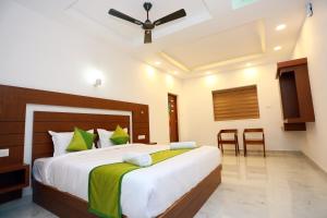 a bedroom with a large bed in a room at CANDLE WOOD MUNNAR in Anachal