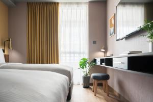 Voodi või voodid majutusasutuse Kindness Day Hotel toas