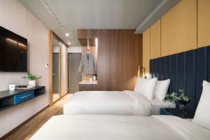 Voodi või voodid majutusasutuse Kindness Day Hotel toas
