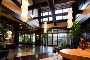 a lobby with large windows and a wooden table at Takayama Ouan in Takayama