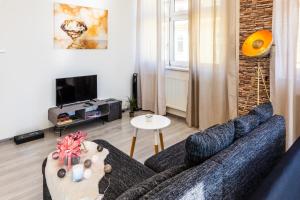 a living room with a couch and a table at Modern apartments Brno-center in Brno