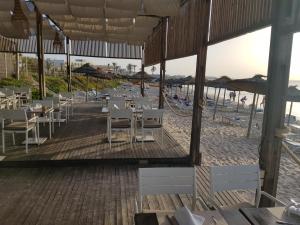 a restaurant on the beach with tables and chairs at Royal Thalassa Monastir in Monastir