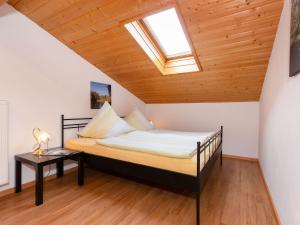 a bedroom with a bed with a skylight at Haus Koch-Lechner in Marquartstein