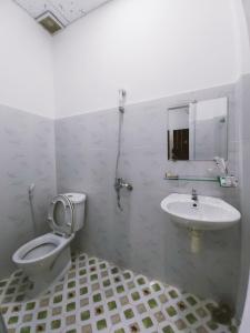 a bathroom with a toilet and a sink at The Sun Hotel in Tây Ninh