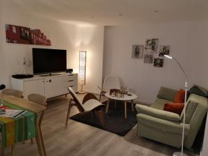 a living room with a tv and a couch and a table at Apartment Potsdam in Potsdam