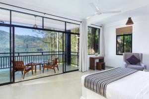 a bedroom with a bed and a balcony at The Farm Resorts in Hatton
