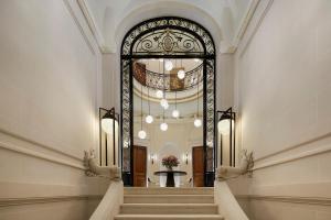 a hallway with a staircase in a building at Maison Villeroy in Paris