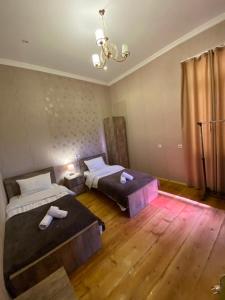 1 Schlafzimmer mit 2 Betten und einem Kronleuchter in der Unterkunft Terrace Mtatsminda in Tbilisi City