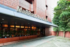 a store front of a marriott building with potted plants at Marroad inn omiya in Saitama