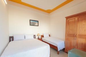En eller flere senge i et værelse på Thinh Phuc Homestay