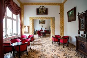 a dining room with red chairs and a table at Polonia in Kudowa-Zdrój