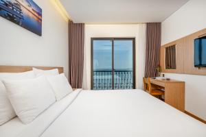 a bedroom with a large bed and a balcony at Gold Boutique Hotel Danang in Da Nang +36 photos