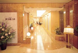 a hallway in a building with flowers and lights at Marroad inn omiya in Saitama