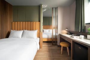 Voodi või voodid majutusasutuse Kindness Day Hotel toas