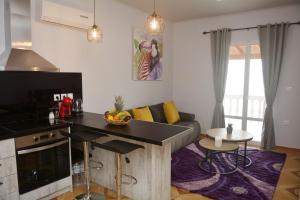 a kitchen and living room with a couch and a table at Sunrise View Apartments in Barbati