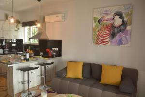 a living room with a couch and a kitchen at Sunrise View Apartments in Barbati