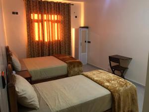 Uma cama ou camas num quarto em Hôtel Afoulki Tiznit