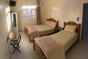 Uma cama ou camas num quarto em Hôtel Afoulki Tiznit