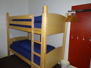 a bunk bed in a room with a blue mattress at Tobermory Youth Hostel in Tobermory