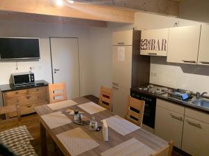 a kitchen with a table and a kitchen with a sink at Hotel Stegmann's Hof in Sehnde