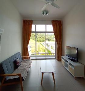 a living room with a couch and a tv at Cameron 2Room Square @Golden Hill in Cameron Highlands