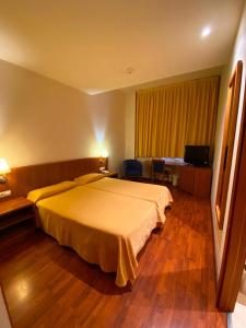 Postel nebo postele na pokoji v ubytování Hotel Berga Park