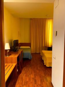 Postel nebo postele na pokoji v ubytování Hotel Berga Park