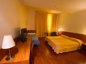 Postel nebo postele na pokoji v ubytování Hotel Berga Park