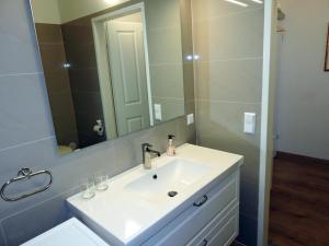 a bathroom with a white sink and a mirror at 212 St Petersburg, Studio Apartment, 27m2, 1-2 Pers in Klagenfurt +19 photos
