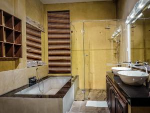 a bathroom with two sinks and a tub and a shower at Gangula Villa in Kandy +161 photos