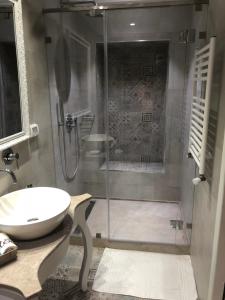 a bathroom with a glass shower and a sink at Dar Corniche La Marsa (Adults Only) in La Marsa