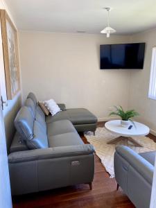 a living room with a couch and a table at Central Views in Jurien Bay