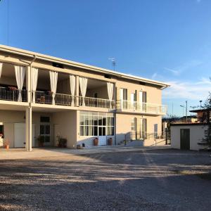 a large white building with white curtains on it at Corte Viviani in Brescia