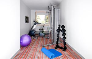 a room with a gym with a treadmill and a mirror at Ginger Pune Wakad in Pune