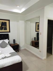 a bedroom with a bed and a large mirror at Bourbon St Apts Condo 16 in Angeles