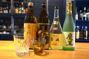 a group of bottles of wine on a table with a glass at Isahaya Daiichi Hotel in Isahaya