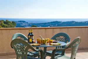 una mesa con sillas y una botella de vino en el balcón en Club Villamar - Abel, en Lloret de Mar