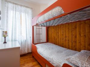 1 dormitorio con 2 literas y ventana en Appartamento Ciliegio Le Regine, en Abetone