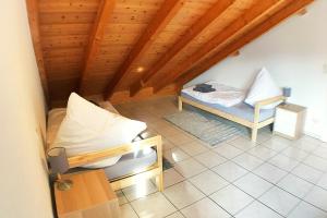 an attic room with a bed and a chair at Workers Apartment- three room apartment with kitchen and wifi in Büsingen