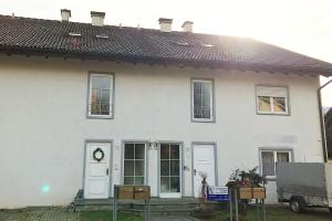 a white house with a white door and windows at Workers Apartment- three room apartment with kitchen and wifi in Büsingen