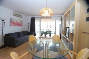 a living room with a glass table and chairs at DIFFERENTFLATS Santa Rosa in Salou