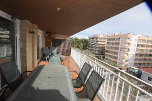 a balcony with chairs and tables on a building at DIFFERENTFLATS Santa Rosa in Salou