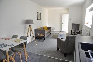 a living room with a couch and a table at Toothbrush Apartments - Central Ipswich - Fore St in Ipswich
