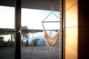 a hammock hanging from a window in a house at Galery69 in Dorotowo