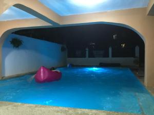 a swimming pool in the middle of a house at Larosa Hostel Bed and Breakfast in Puerto Princesa City