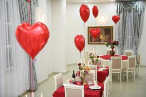 a room with red heart balloons on the wall at Hotel Belagrita in Berat