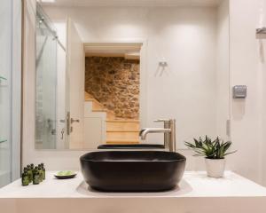 a bathroom with a black bowl sink on a counter at Aldia Suites Arachova in Arachova