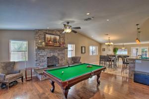 a living room with a pool table and a fireplace at Pet-Friendly Glendale Home with Pool and Putting Green in Phoenix