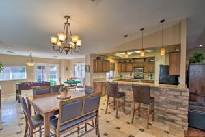 a kitchen and dining room with a table and chairs at Pet-Friendly Glendale Home with Pool and Putting Green in Phoenix