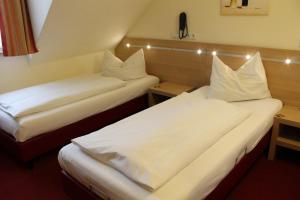Postel nebo postele na pokoji v ubytování Hotel Scholz